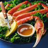 Alaska Bairdi snow crab cluster in bed of lettuce with melted butter & lemon wedge.