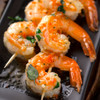 Cooked Alaska spot shrimp on wooden skewers.
