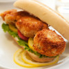 Crispy crab cake sandwich with lettuce and tomato.