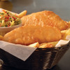 Pubhouse battered cod fillets in a basket with fries & coleslaw.