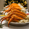 Platters piled high with golden king crab legs.