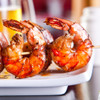 Delicious grilled jumbo shrimp on a wooden skewer.