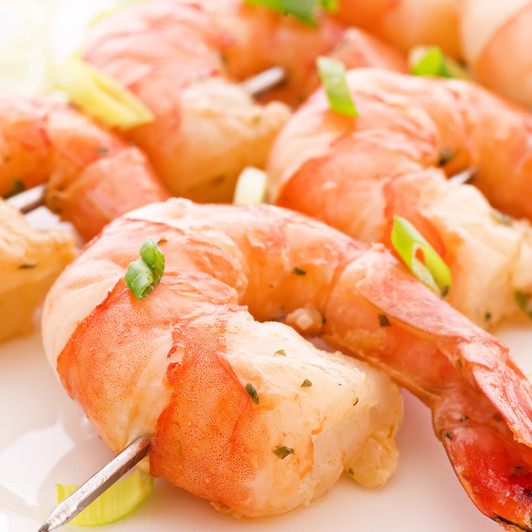 Jumbo shrimp on a stainless steel skewer.