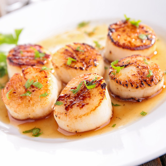 Delicious caramelized Alaska scallops on a plate.