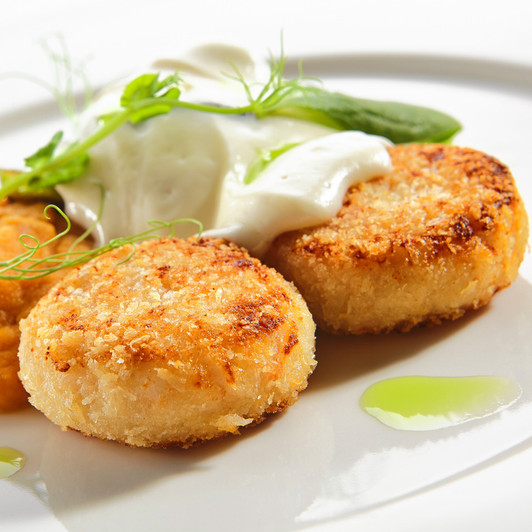 Crispy golden crab cakes with gourmet sauces.