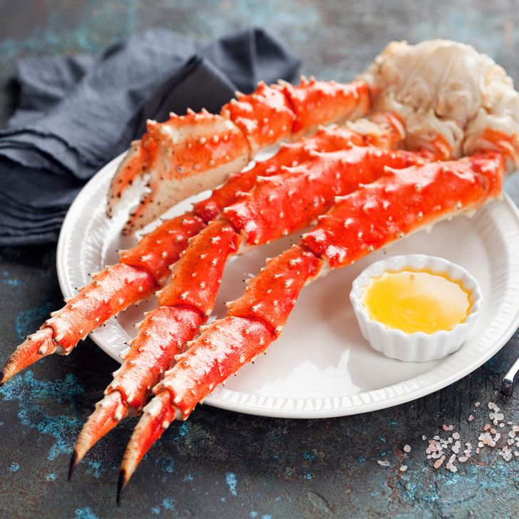 A bright red king crab cluster with a ramakin of hot melted butter.