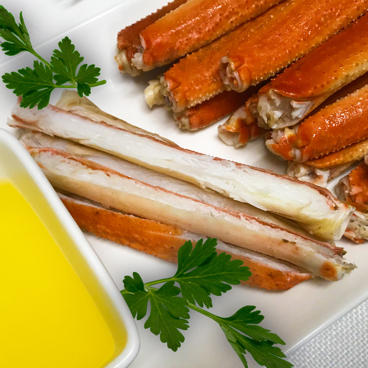 Cut open snow crab merus sections with melted butter.