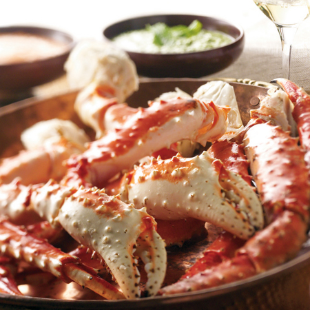 Steamed Alaska red king crab legs and claws with dipping sauces