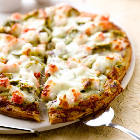 Flat bread pizza stacked with crab, jalapenos, onions, & cheese