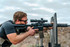 Man on barricade with SOLGW L89 rifle mounted with Nightforce Optics NX6 1-6x24mm F1 riflescope in a black 1.54 Ultramount, shooting at an outdoor range C726).