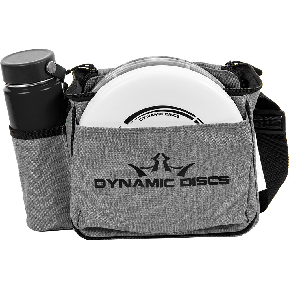 Front view of heathered gray Dynamic Discs Cadet starter bag. Shows water bottle in pocket on side to viewer's left, white disc in front pocket, and a single strap. Has black Dynamic Discs logo on front.