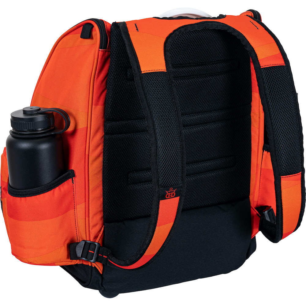 Angled back view of Dynamic Discs Commander Backpack Bag in Infrared Orange color featuring black detailing.