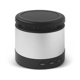A wireless speaker and charging device in silver and black, featuring control buttons on the base and a sleek design.