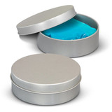 A silver tin with a lid partially open, revealing blue stress putty inside. Another closed tin is beside it.