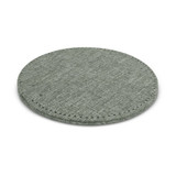 A round, fabric-covered wireless charger in a muted green shade with stitched edges.