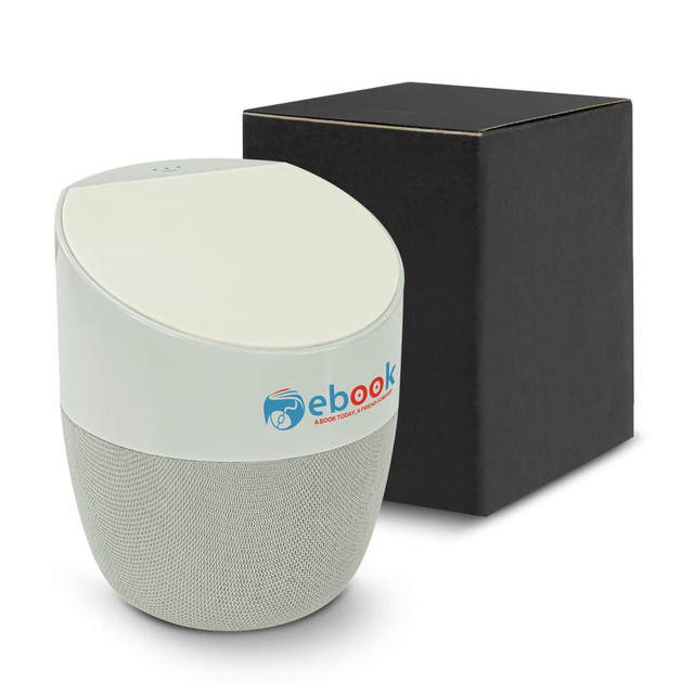 A wireless charger and speaker in a light green colour, accompanied by a black box. Features a logo on the speaker.