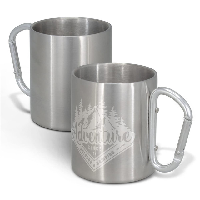 A stainless steel coffee mug with a carabiner-style handle and a logo design featuring mountains and trees.