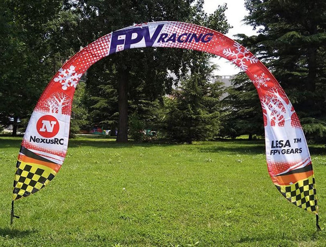 A curved arch banner measuring 3000mm x 2500mm with a red, white, and checkered design, featuring a logo.