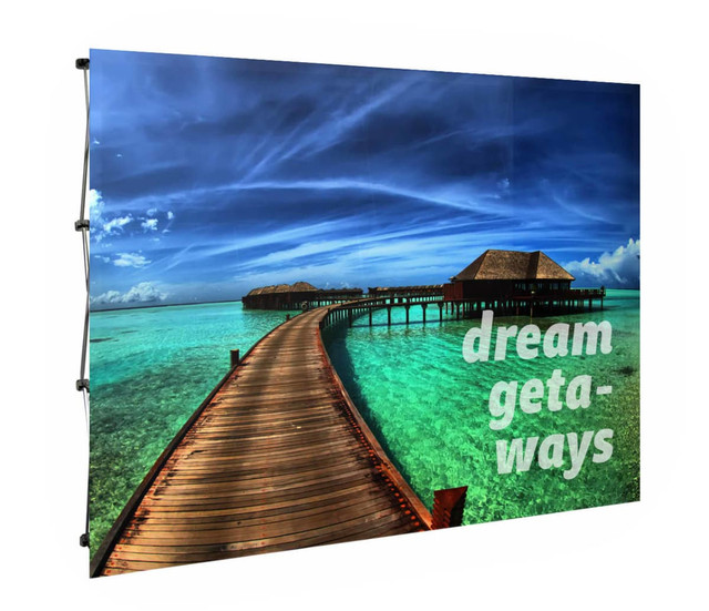A large promotional display featuring a scenic image of a turquoise ocean with wooden walkways and text in white.