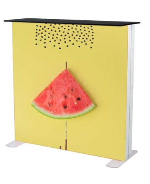 A promotional light box table featuring a bright yellow design and a 3D watermelon slice on the front.