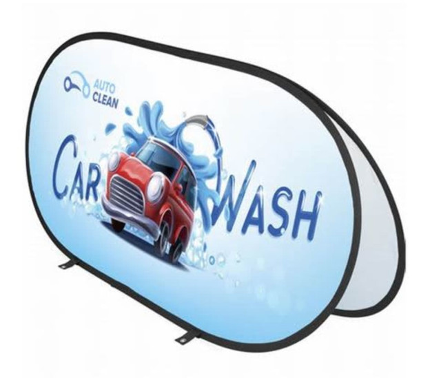 A pop-up banner featuring a red car in water, with a blue background and a logo. The banner is oval-shaped.
