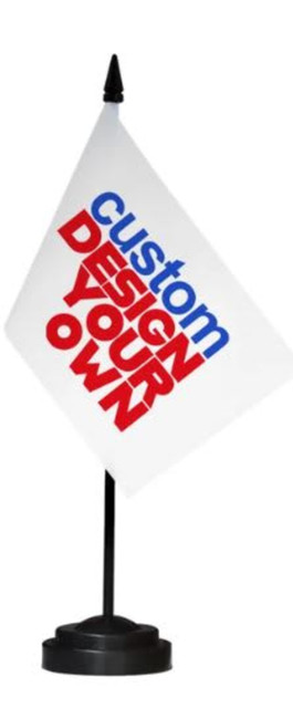 A desk top flag featuring a white flag on a black stand displaying the words "custom design your own" in red and blue.