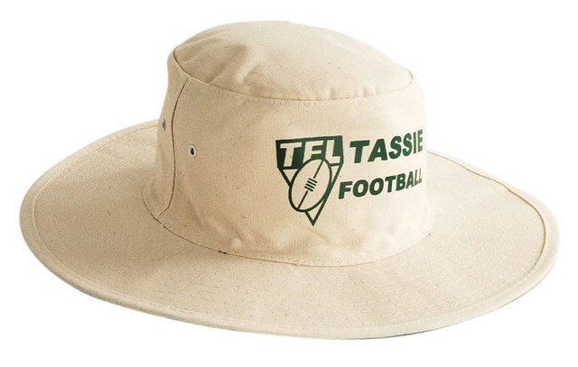 A beige canvas hat with a broad brim and a logo on the front.