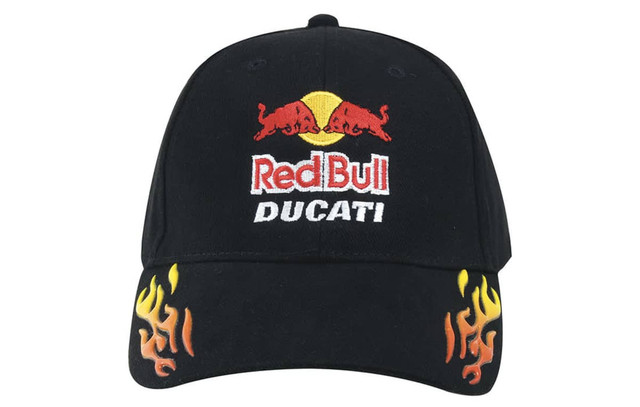 A black cap featuring a logo and flames in yellow and orange designs on the brim. It has a brand logo.