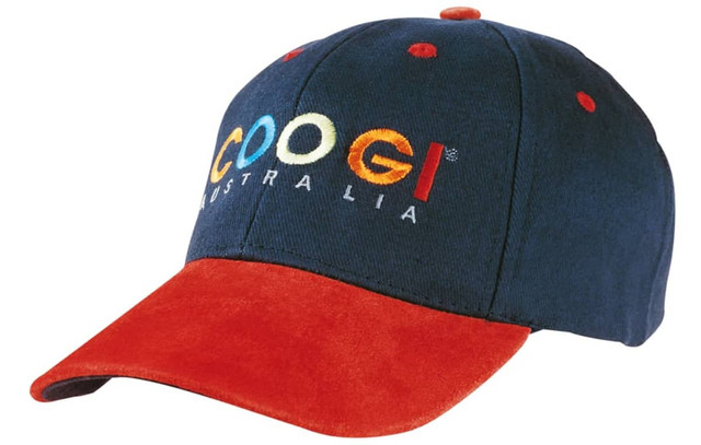 A cap featuring a navy blue cotton body with a red suede peak and a logo on the front.