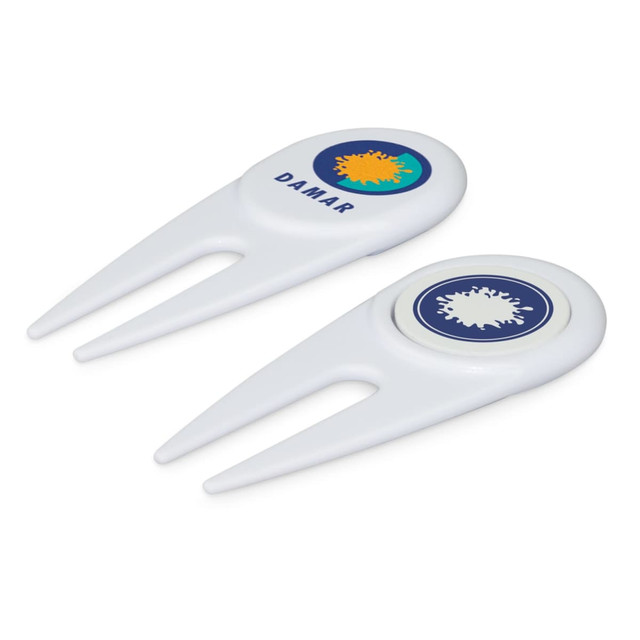 A white golf divot repairer with a marker, featuring circular designs and a logo on each side.
