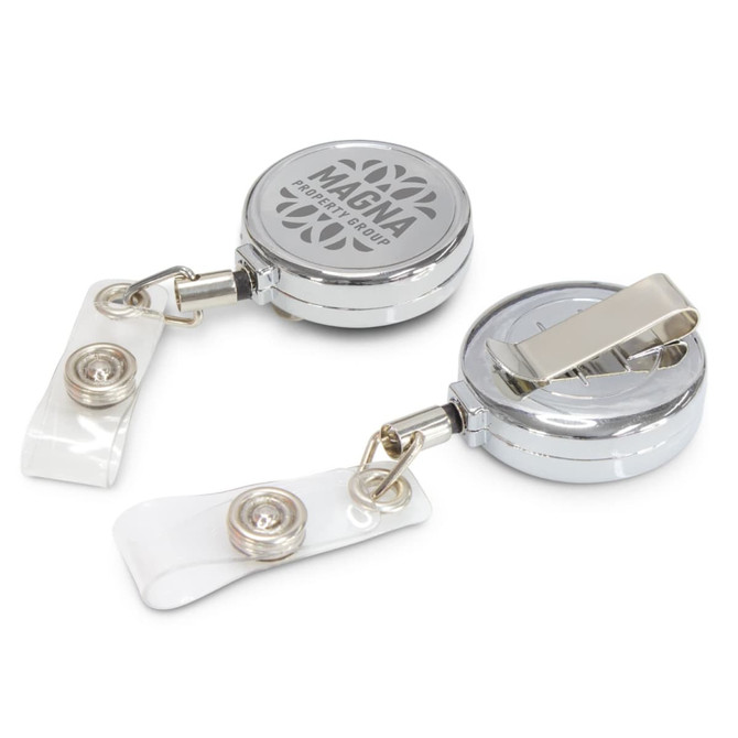A silver retractable ID holder with a clip and clear strap, featuring a logo on the surface.