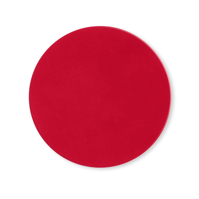 A round, red silicone jar opener with a smooth surface and no visible branding.