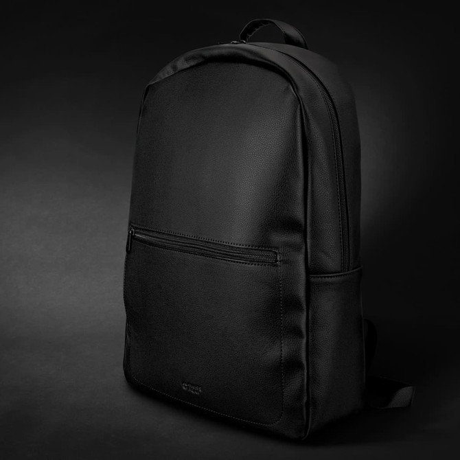 A black Swiss Peak Deluxe Backpack with a smooth texture and a front zipper pocket, featuring a logo.