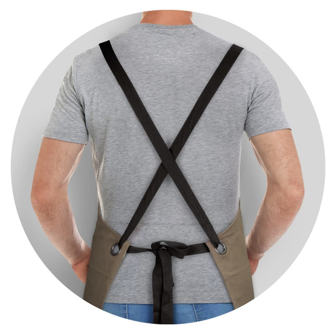 A khaki bib apron with black straps, viewed from the back, on a person wearing a grey shirt.