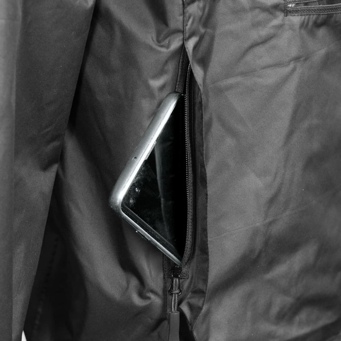A close-up view of a black windbreaker jacket featuring a zippered pocket with a smartphone inside.