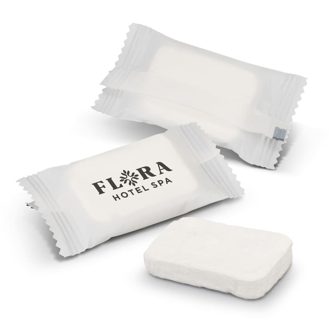 Compressed towels in white packaging, with an accompanying towel in a rectangular shape. One package features a logo.