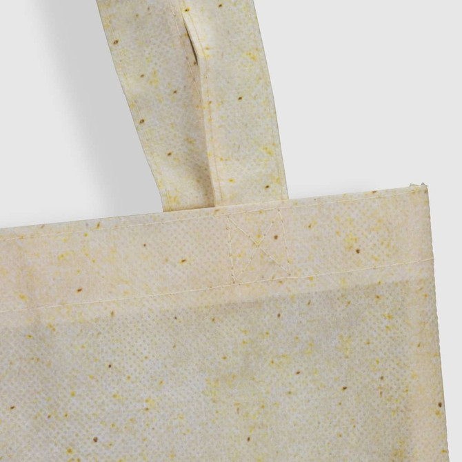 A small tote bag in a natural look with a textured finish, featuring a woven handle and a subtle colour pattern.