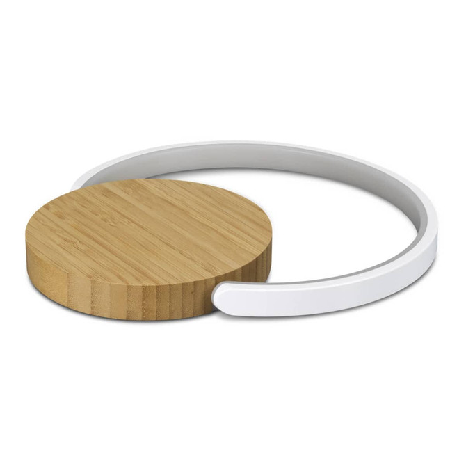A round wireless charging pad with a bamboo top and a white base, featuring a minimalist design.