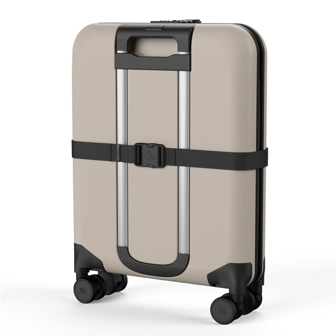 A beige wheeled suitcase with a slim design, featuring a handle, wheels, and a black strap.