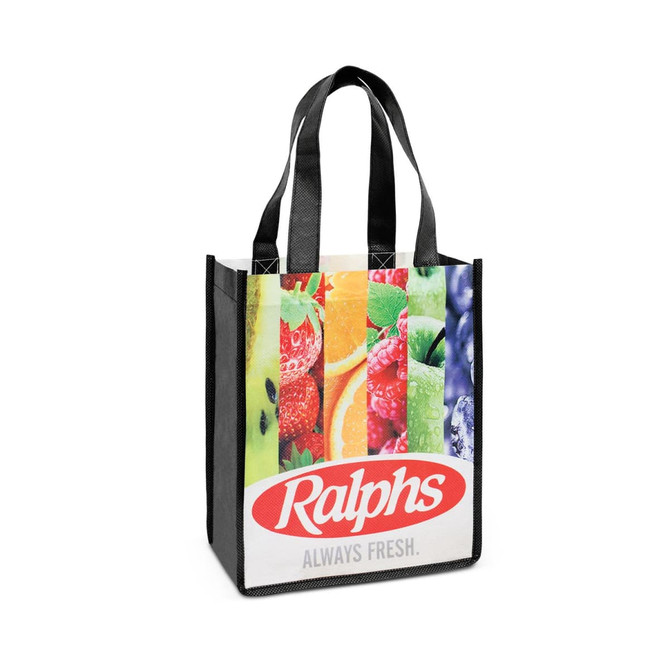 A tote bag featuring a colourful fruit design and black handles, with branding on the front.