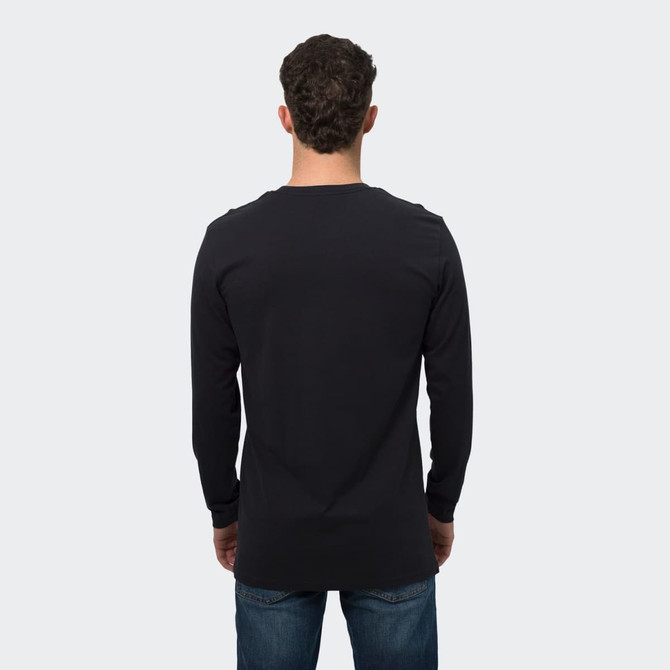 A man wearing a black long sleeve crew shirt, shown from the back, with denim jeans. The shirt features a logo.