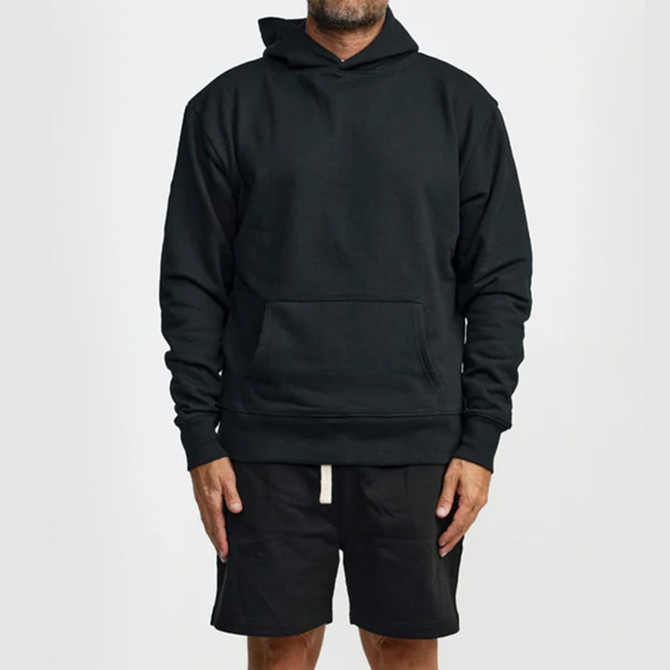 A black hoodie with a front pocket and a hood, paired with black shorts. The model stands in a neutral position.