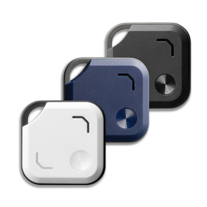 Three VibeTag Bluetooth trackers in white, navy blue, and black, featuring a minimalist design and a corner loop for attachment.