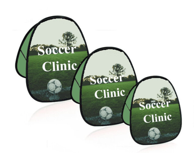 Three green pop-up banners featuring a soccer ball and a landscape with trees, displaying the words "Soccer Clinic."