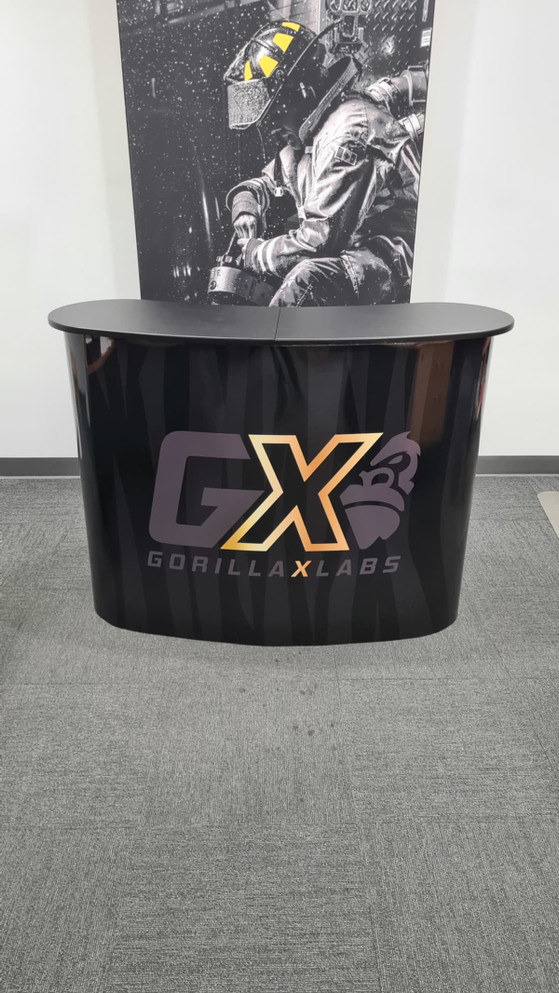 A black promotional table with a curved design features a logo and a smooth glossy finish.