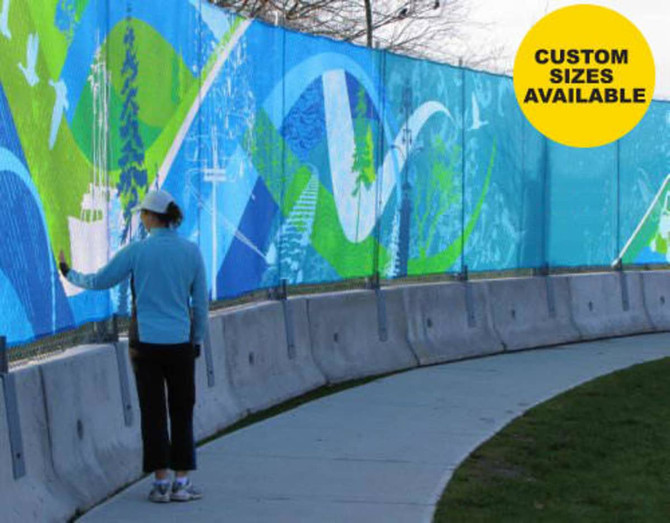 A woman interacts with a vibrant, multi-coloured mesh polyester banner along a curved pathway. The banner features abstract designs and a logo.