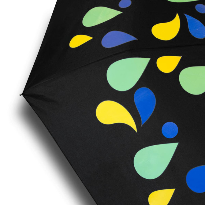 A compact umbrella featuring a black canopy adorned with colourful droplets in green, yellow, and blue. It has a branding logo.