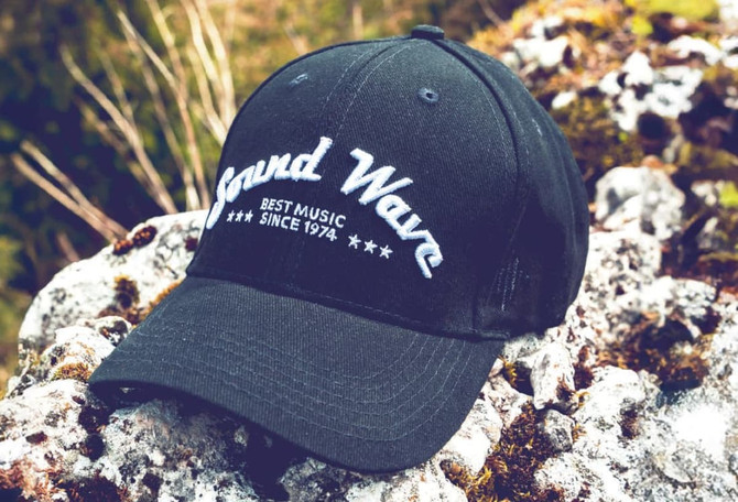 A black cap with a curved visor and a logo featuring the words "Sound Wave" on the front.