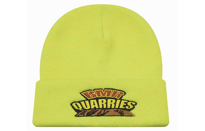A bright yellow beanie hat with a folded cuff and a logo on the front.