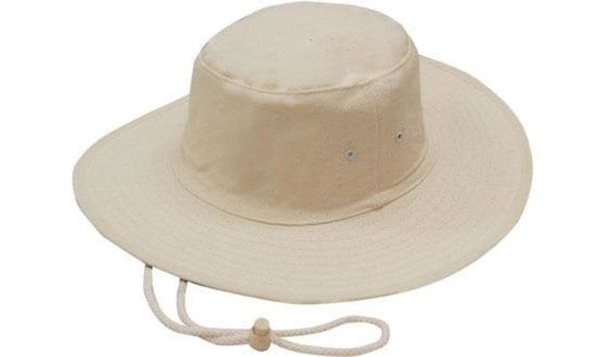 A beige canvas hat with a wide brim and a drawstring. Features ventilation holes and a logo.
